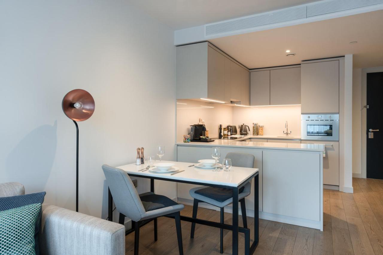 Citysuites Aparthotel Salford  Ngoại thất bức ảnh The photo shows a modern and stylish kitchen and dining area. The kitchen features sleek cabinets with a subtle color palette and built-in appliances, including an oven and possibly a stovetop. A countertop is visible, with kitchen utensils and small
